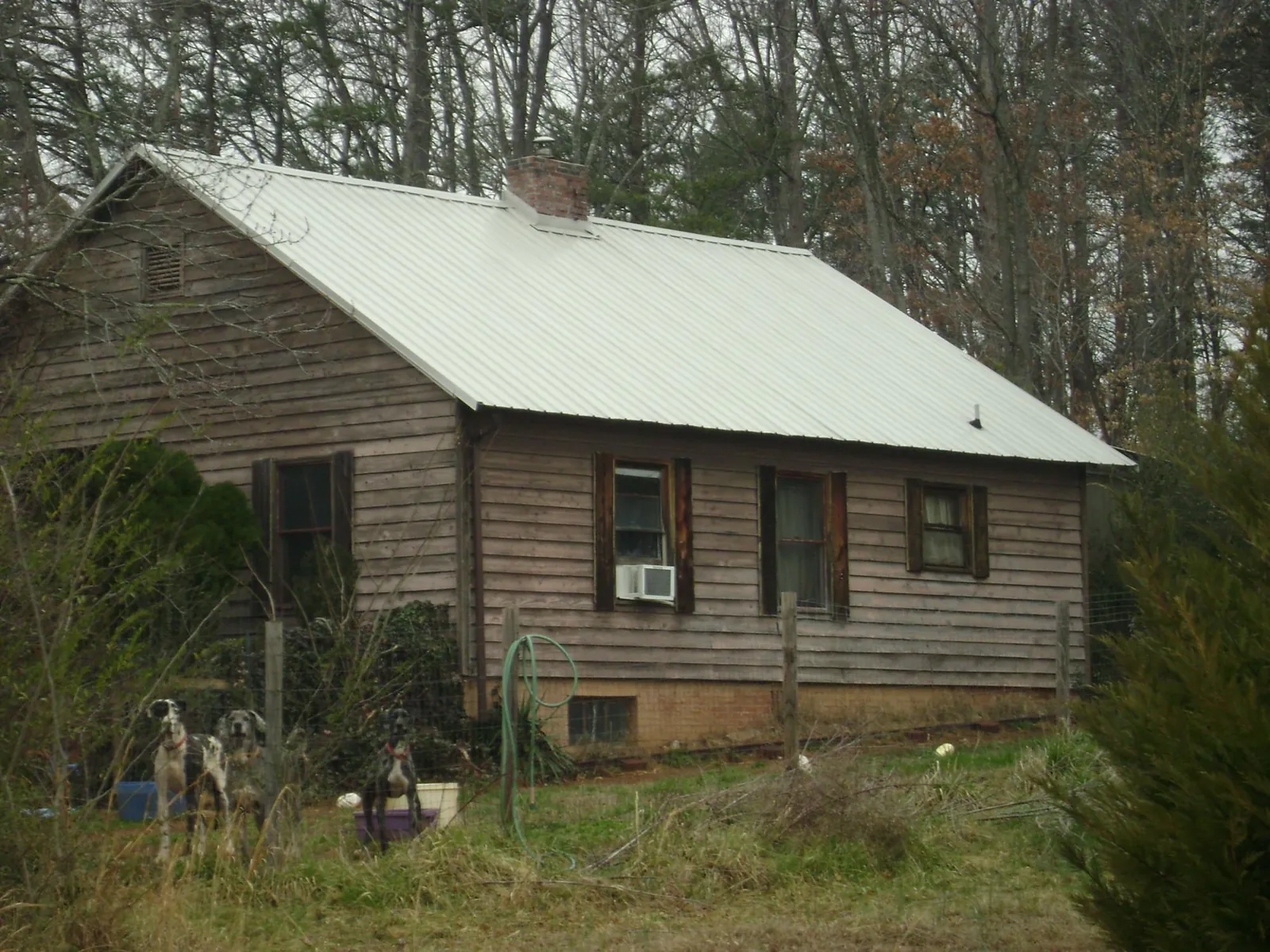 White metal roof on an old wood sided farmhouse, from a Metal Roof Installation job in Emerson